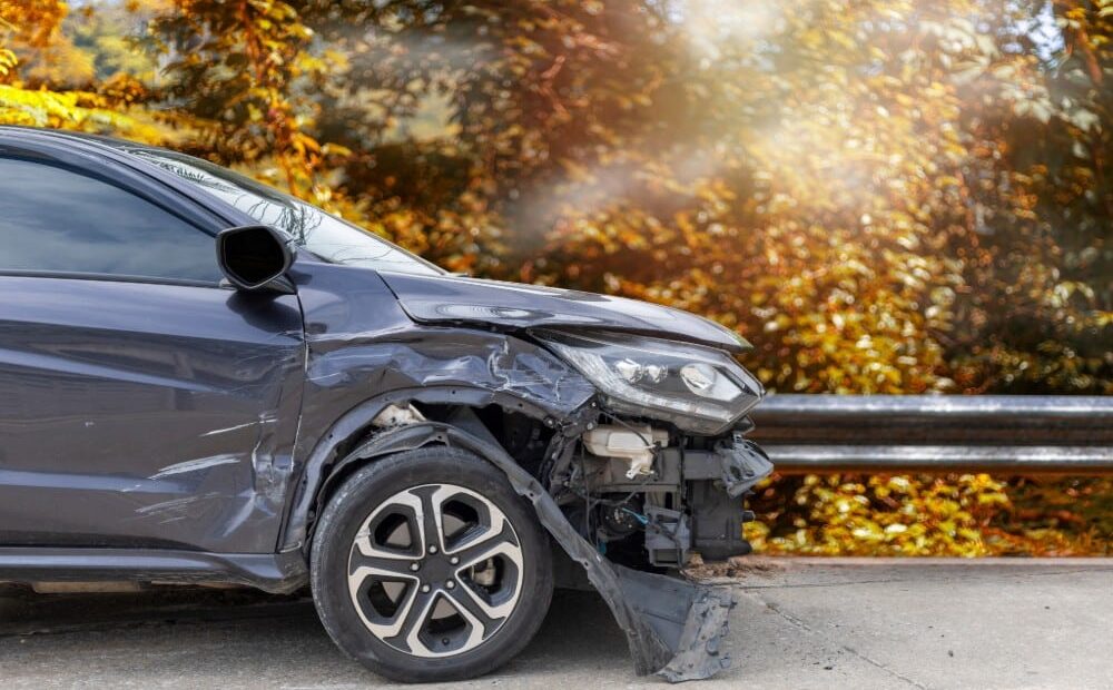 Importance of photos after a car accident Morgan County Georgia portrayed by a black car with a smashed front-end.