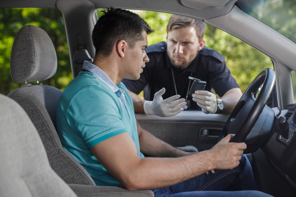 Police talking to young man in the car - Blood Alcohol Content Calculator